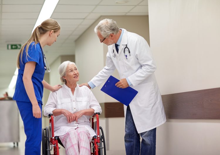 Doctor, nurse and patient in a hospital hallway