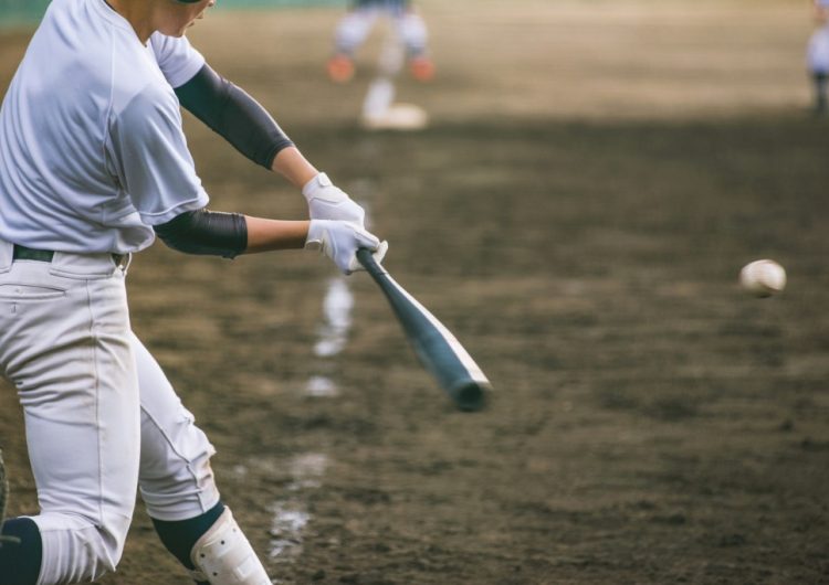 Baseball player about to hit a ball